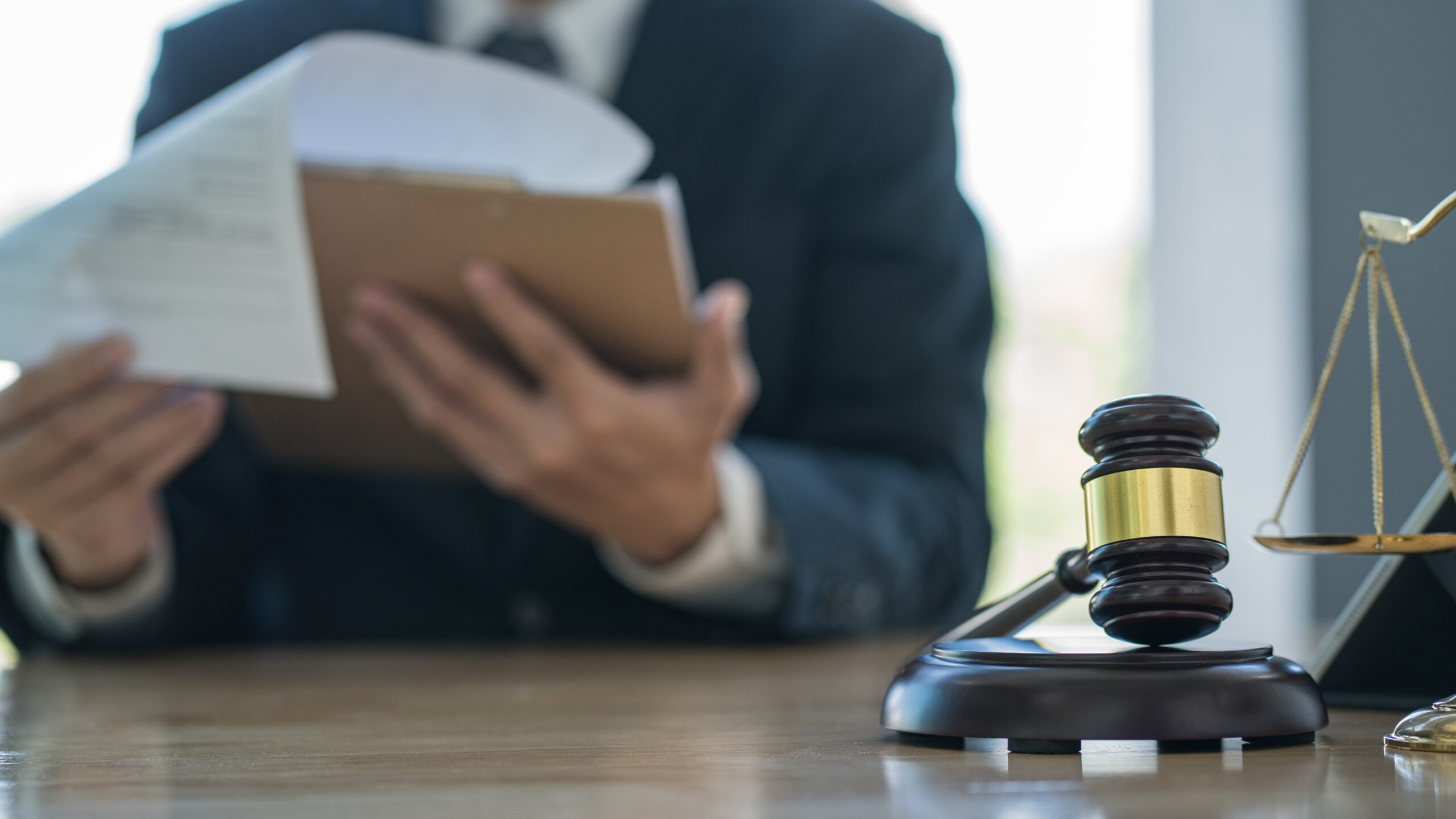 Male judge in a courtroom with the gavel Male judge in a courtroom with the gavel