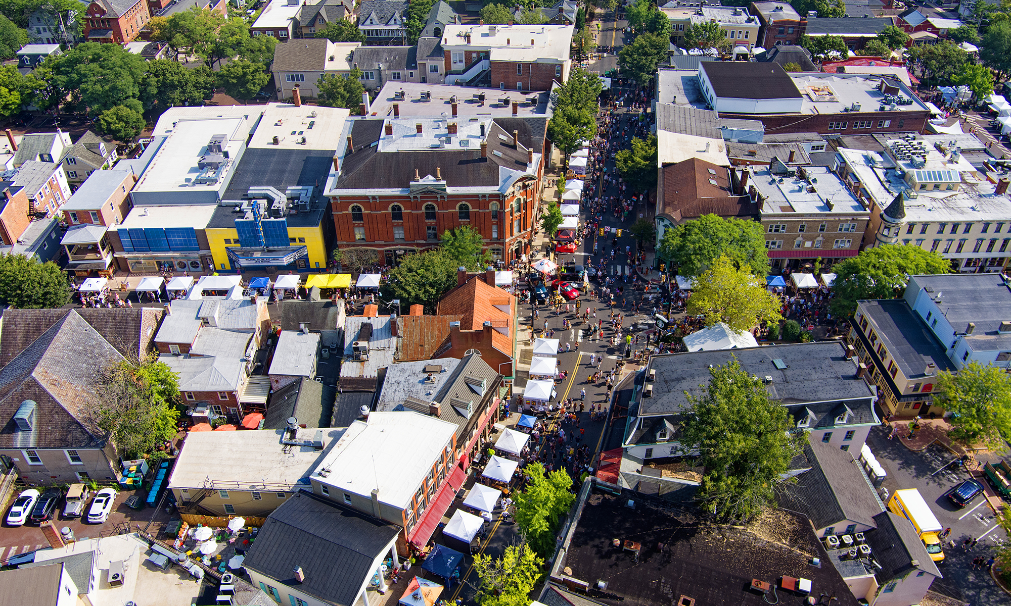 Aerial view of downtown Doylestown, Pennsylvania, showing historic brick buildings, tree-lined streets, and small-town architecture 