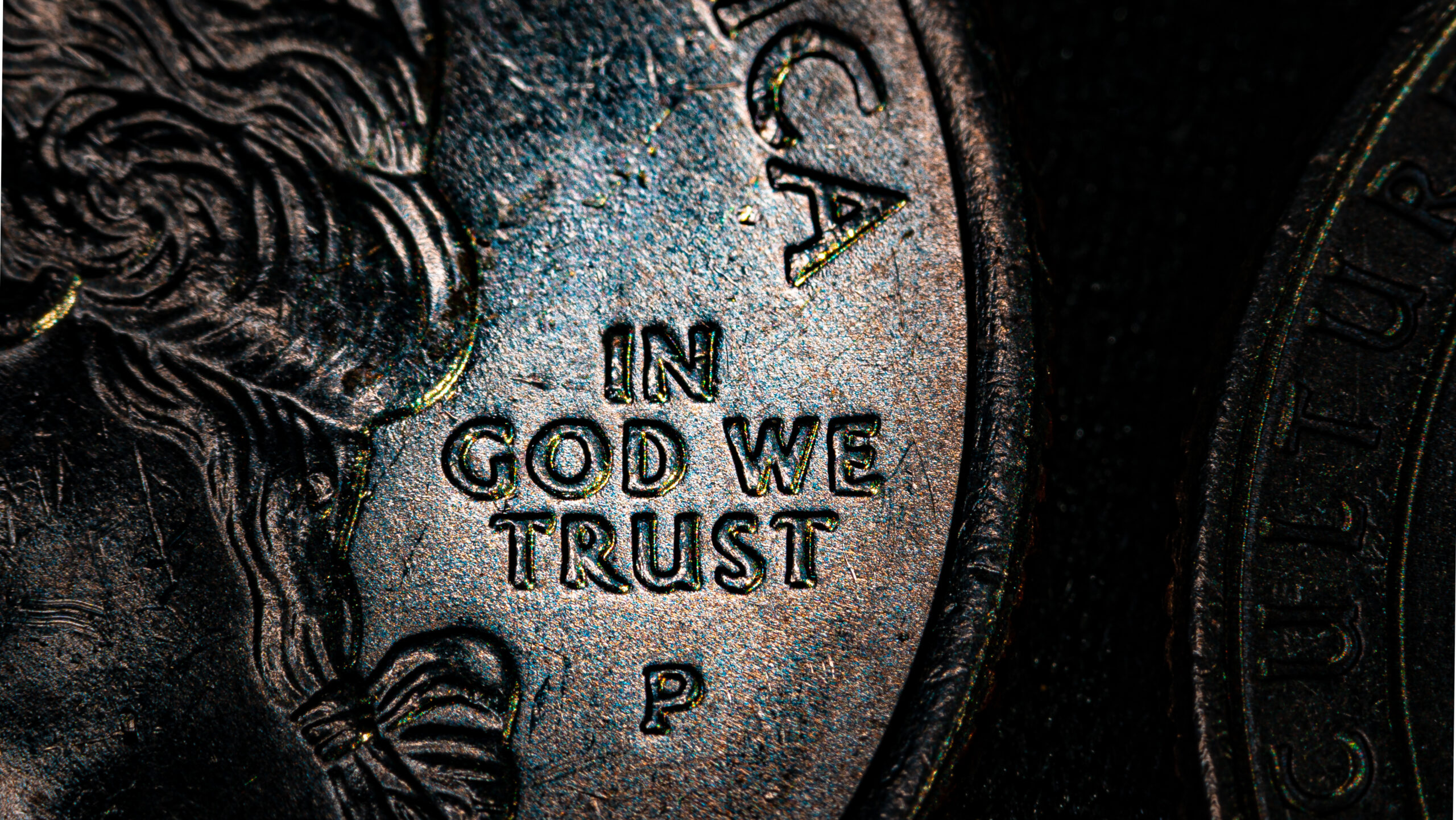 Close up shot of coin with the phrase, “In God we trust.”