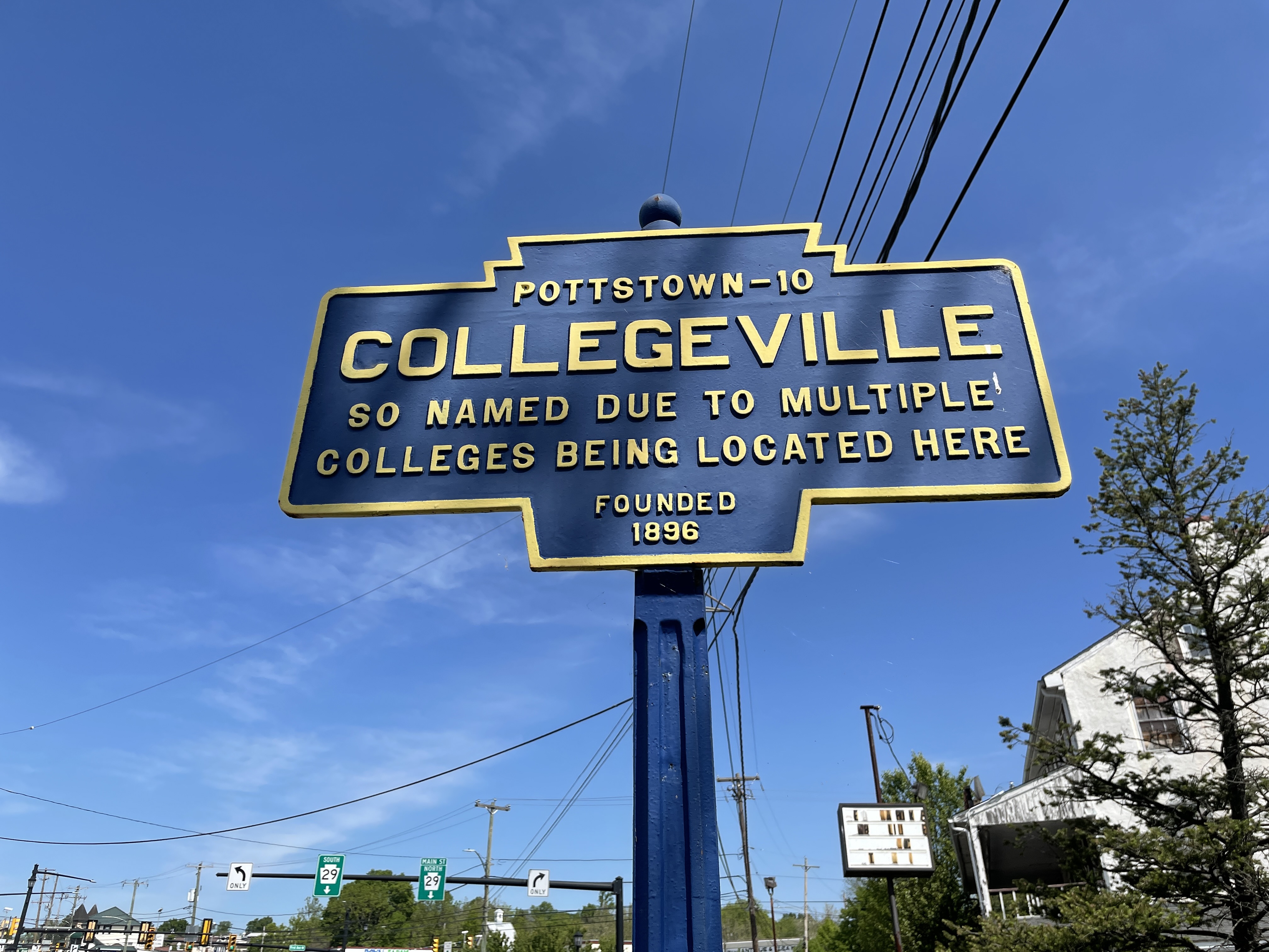 Pennsylvania Keystone Marker along Main Street in Collegeville, Pennsylvania, displaying the borough name and founding information.